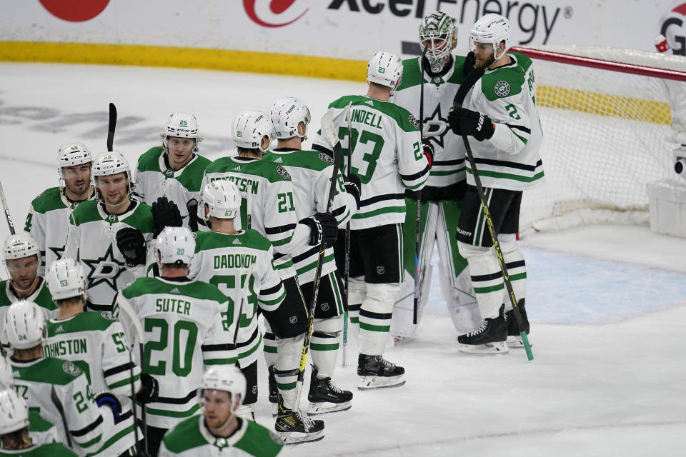 Dallas Stars goaltender Jake Oettinger, second from right, celebrates with teammates following their 4-1 win over the Minnesota Wild in Game 6 of an NHL hockey Stanley Cup first-round playoff series Friday, April 28, 2023, in St. Paul, Minn. The Stars won the series. (AP Photo/Abbie Parr)