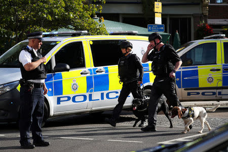 Police officers and sniffer dogs walk near Parsons Green tube station in London, Britain September 15, 2017. REUTERS/Hannah McKay