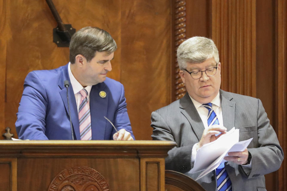 South Carolina House Speaker Murrell Smith, R-Sumter, left, and House Clerk Charles Reid, right, review several amendments to a hate crimes bill to see if they are out of order, on Wednesday, March 8, 2023, in Columbia, S.C. (AP Photo/Jeffrey Collins)