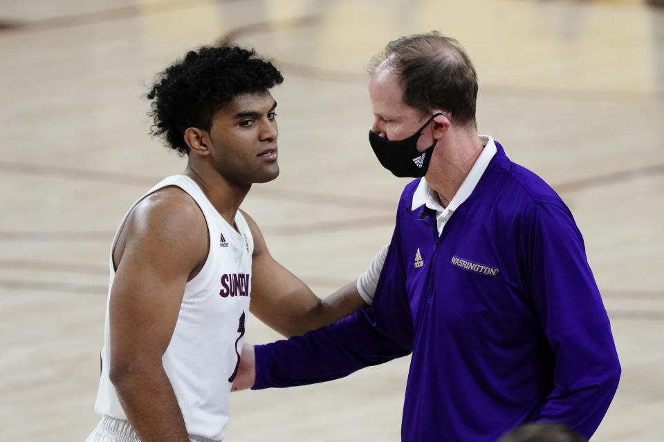 Arizona State guard Remy Martin (1) and Washington head coach Mike Hopkins talk during the second half of an NCAA college basketball game, Thursday, Feb. 25, 2021, in Tempe, Ariz. (AP Photo/Rick Scuteri)