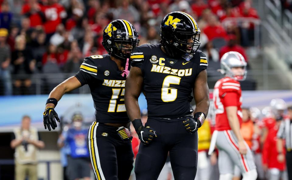 Dec 29, 2023; Arlington, TX, USA; Missouri Tigers defensive lineman Darius Robinson (6) and Missouri Tigers defensive back Daylan Carnell (13) celebrate during the first quarter against the Ohio State Buckeyes at AT&T Stadium. Mandatory Credit: Kevin Jairaj-USA TODAY Sports