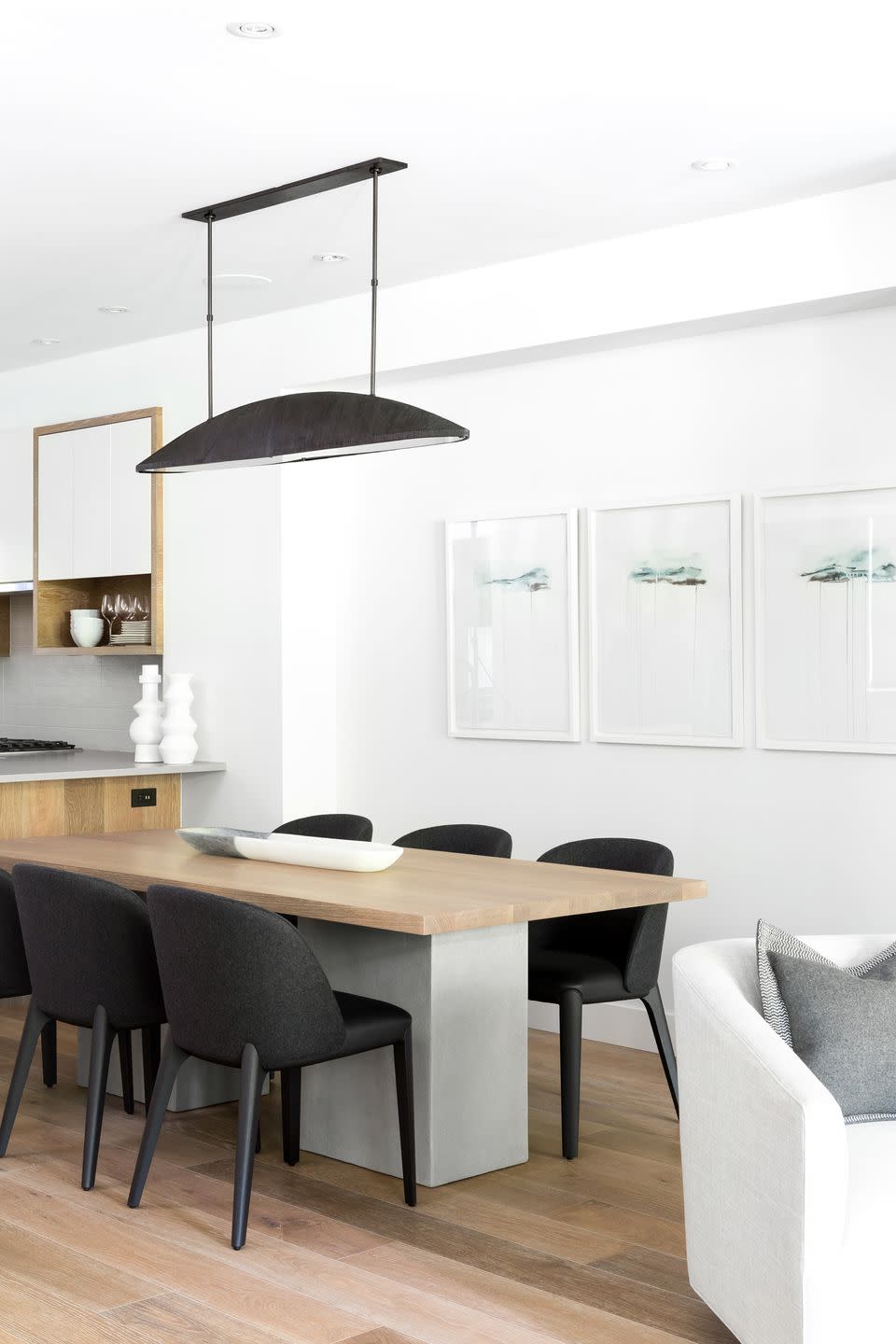 A modern dining table captivates this black and white space