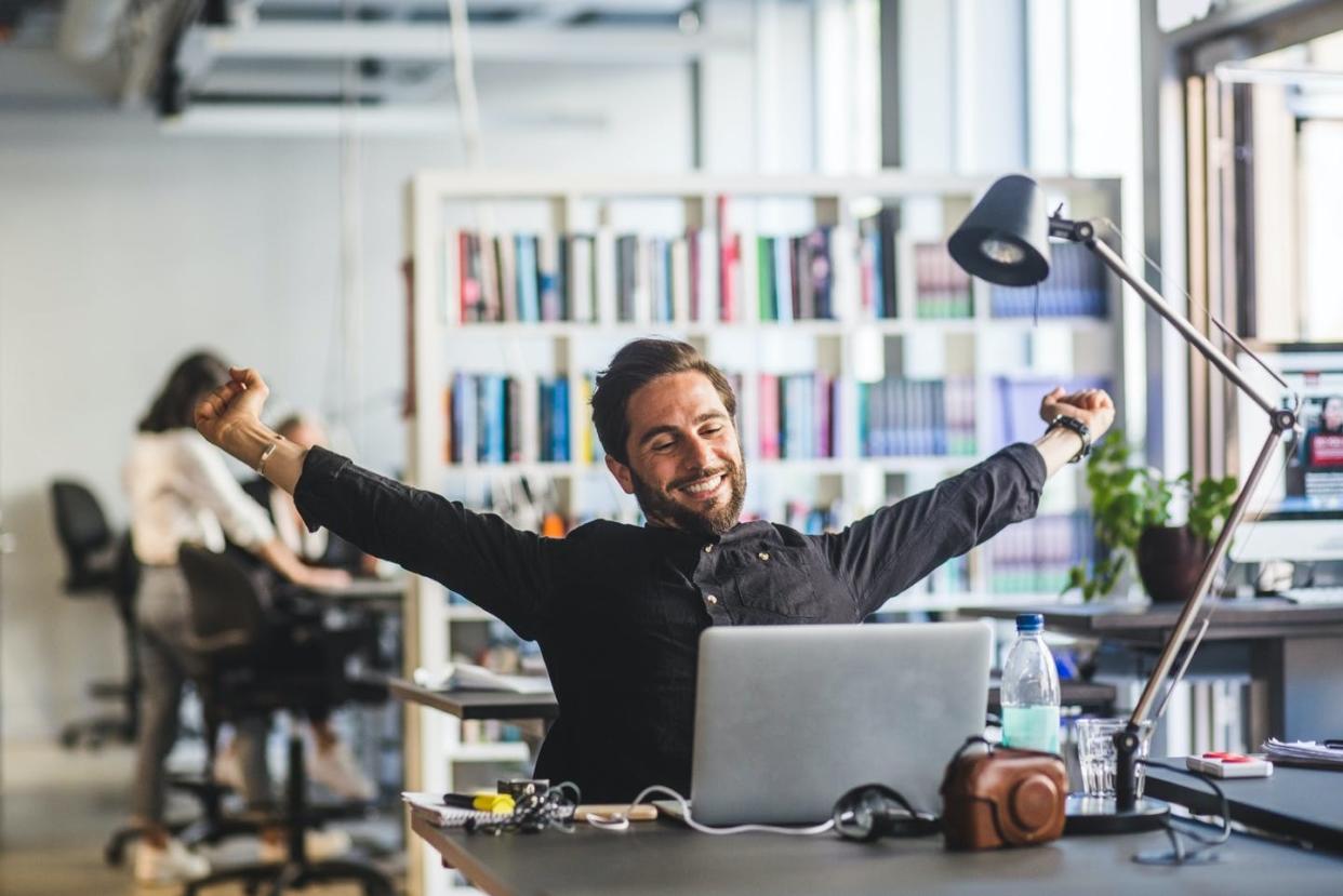 <span class="caption">Surveys suggest job satisfaction is still quite high. </span> <span class="attribution"><a class="link " href="https://www.gettyimages.com/detail/photo/businessman-sitting-with-arms-outstretched-at-desk-royalty-free-image/1073867624" rel="nofollow noopener" target="_blank" data-ylk="slk:Maskot/Getty Images;elm:context_link;itc:0;sec:content-canvas">Maskot/Getty Images</a></span>