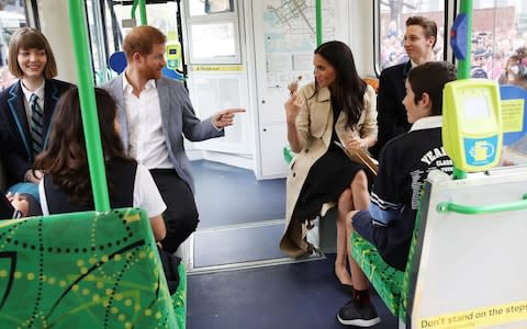 The Duke and Duchess of Sussex talk to students from Albert Park Primary School while riding a tram in Melbourne - Credit: Chris Jackson /Getty