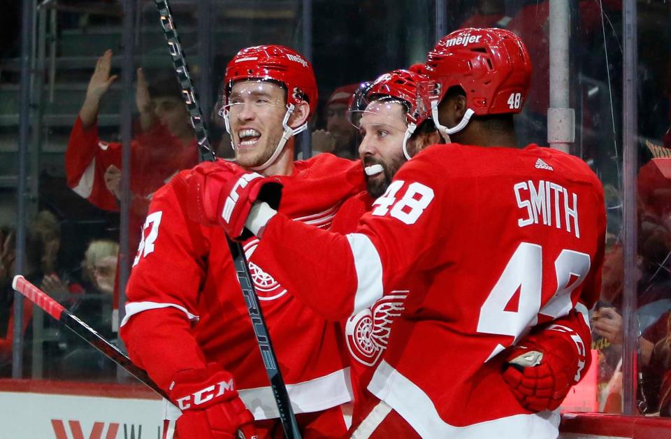 Detroit Red Wings center Sam Gagner, center, celebrates his goal against the New York Islanders with center Carter Rowney, left, and right wing Givani Smith (48) during the first period of an NHL hockey game Saturday, Dec. 4, 2021, in Detroit.