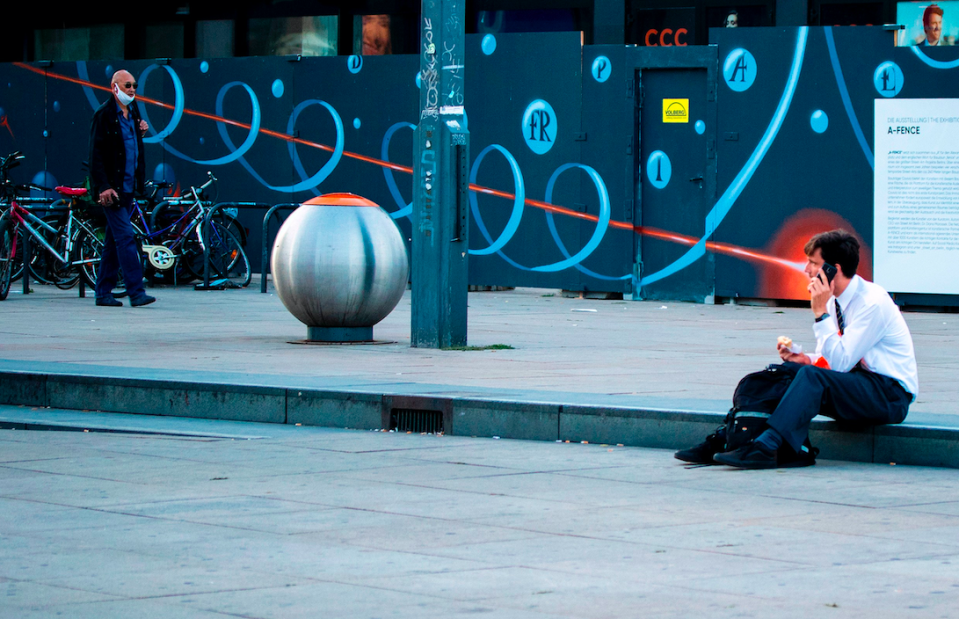 A man looks like he is shooting a laser from his eyes in Berlin, Germany.