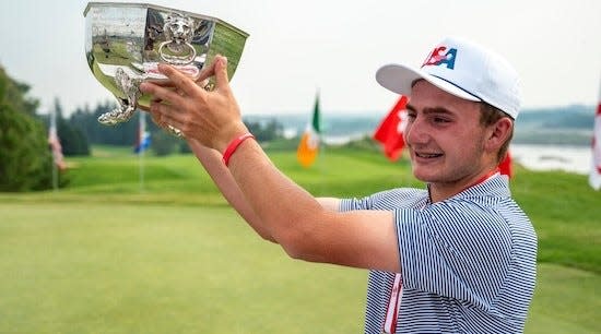 Fleming Island's Tyler Mawhinney holds the Earl Grey Cup for winning the Canadian Amateur tournament Aug. 8 at Riverside Country Club in Saskatoon.