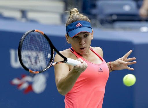 Simona Halep, of Romania, returns a shot to Kirsten Flipkens, of Belgium, during the first round of the U.S. Open tennis tournament, Tuesday, Aug. 30, 2016, in New York. (AP Photo/Frank Franklin II)