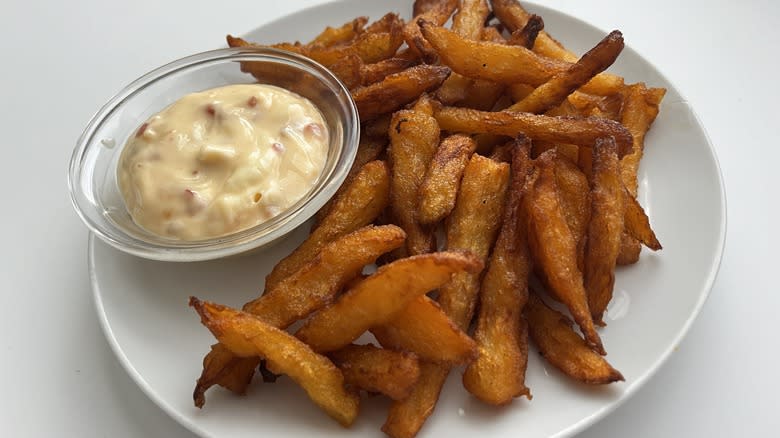 fries with mayonnaise sauce on white plate