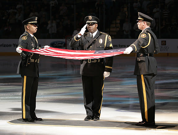 DALLAS - OCTOBER 20: Three fireman salute the flag that hung above Ground Zero for the time following the tragedy of September 11th 2001 as the National Anthem is performed on Firefighter Appreciation Night for the Dallas Stars as they played host to the Anaheim Ducks at the American Airlines Center on October 20, 2007 in Dallas, Texas. (Photo by Glenn James/NHLI via Getty Images)