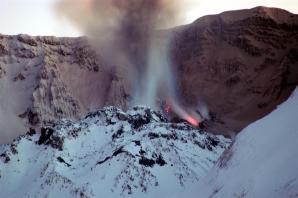 The dome of Mount St. Helens' crater full of snow and glowing red hot