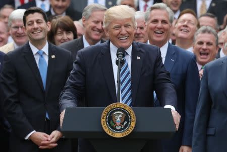 U.S. President Donald Trump (C) celebrates with Congressional Republicans in the Rose Garden of the White House after the House of Representatives approved the American Healthcare Act, to repeal major parts of Obamacare and replace it with the Republican healthcare plan, in Washington, U.S., May 4, 2017. REUTERS/Carlos Barria