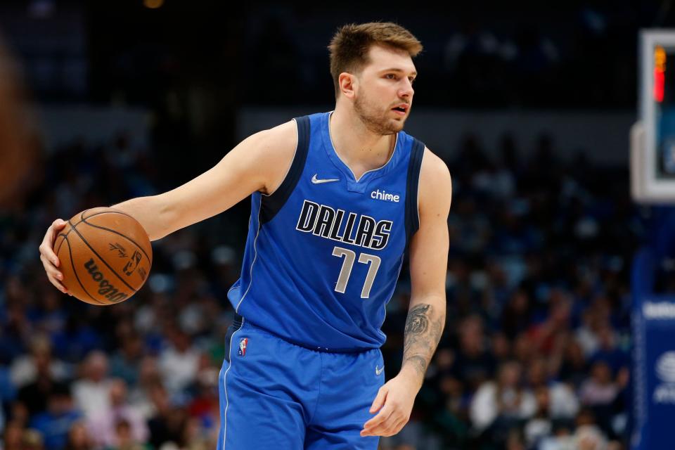 Seen here, Dallas Mavericks star Luka Doncic takes up the basketball in the NBA.