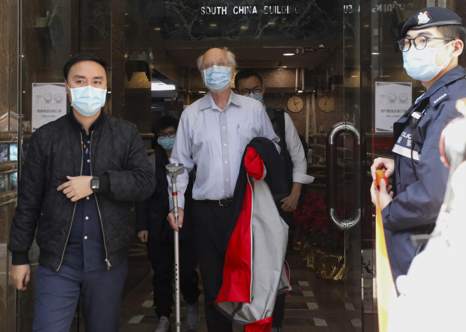 American human rights lawyer John Clancey, center, is arrested by police in Hong Kong Wednesday, Jan. 6, 2021. Clancey was the treasurer of the political group Power for Democracy, which was involved in the unofficial primaries. About 50 Hong Kong pro-democracy figures were arrested by police on Wednesday under a national security law, following their involvement in an unofficial primary election last year held to increase their chances of controlling the legislature, according to local media reports. (AP Photo/Apple Daily)