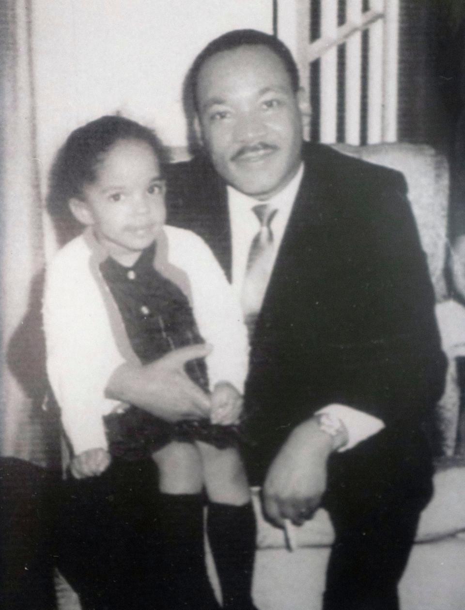 Dr. Martin Luther King, Jr. holds Jawana Jackson on his knee when she was four years old at her family's home. The Jackson and King families were very close friends, said Jackson. Much of King's Selman to Montgomery march was planned in her childhood home.