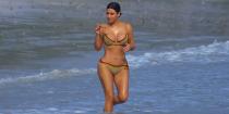 <p>In a red belted vintage Christian Dior bikini and hoops while on vacation in Mexico. </p>