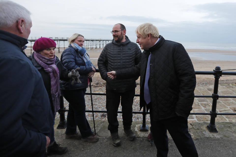 Britain's Prime Minister Boris Johnson talks to residents during a General Election campaign trail stop in Saltburn-by-the-Sea, near Middlesbrough, England, Wednesday, Nov. 20, 2019. Britain goes to the polls on Dec. 12. (AP Photo/Frank Augstein, Pool)