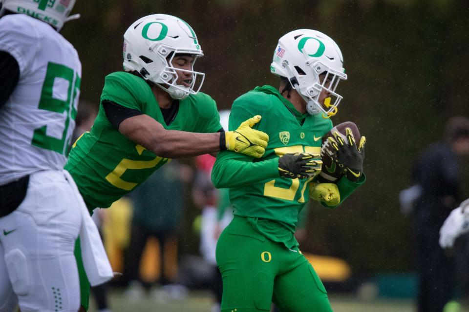 Oregon defensive back Aaron Flowers tackles defensive back Hunter Roberts during practice with the Oregon Ducks April 4 at the Hatfield-Dowlin Complex in Eugene.