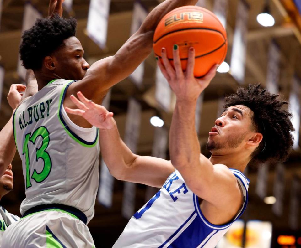 Duke’s Jared McCain (0) shoots while defended by Queens’ Deyton Albury (13) during the second half of Duke’s 106-69 victory over Queens University at Cameron Indoor Stadium in Durham, N.C., Saturday, Dec. 30, 2023.