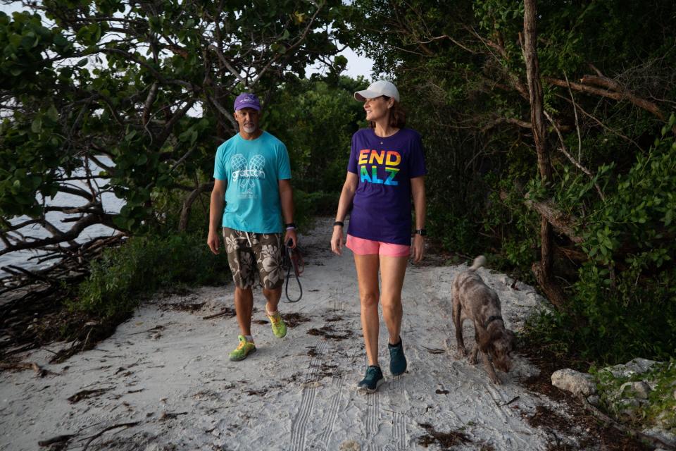 Michele Hall, 55, of Bradenton, Fla., goes on a morning walk with her husband, Doug, at the De Soto National Memorial on Sunday, Sept. 25, 2022, in Bradenton. Michele Hall was diagnosed with Alzheimer’s disease when she was 53. “I can’t read or write or any of that stuff. But I can talk.” | Angelica Edwards, Tampa Bay Times