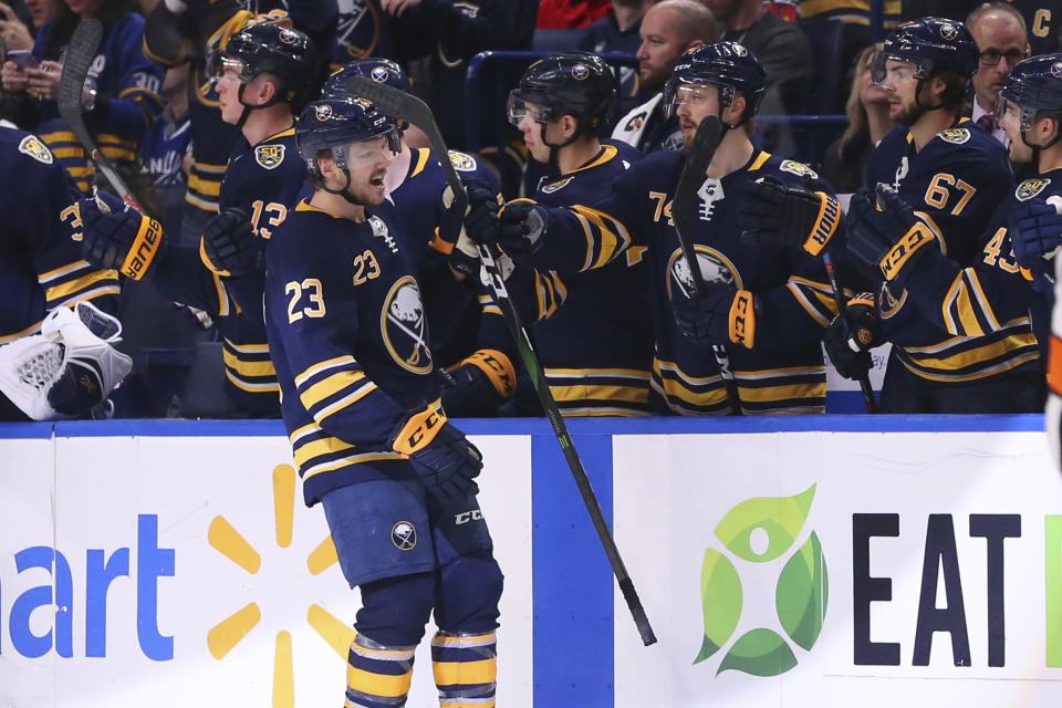 Buffalo Sabres forward Sam Reinhart (23) celebrates with teammates after scoring a goal during the second period of an NHL hockey game against the Vancouver Canucks, Saturday, Jan. 11, 2020, in Buffalo, N.Y. (AP Photo/Jeffrey T. Barnes)