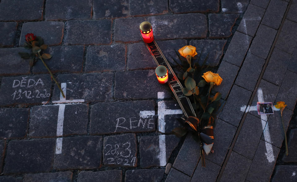 Candles and flowers are placed to pay respect to victims of the COVID-19 pandemic at a spontaneous memorial place set at the Old Town Square in Prague, Czech Republic, Monday, March 29, 2021. The coronavirus pandemic is unleashing enormous suffering as infection rates rise across central Europe even as the Czech Republic and Slovakia, recently among the worst-hit areas in the world, are finally seeing some improvements following tight lockdowns. (AP Photo/Petr David Josek)