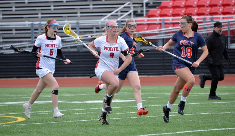 North Hagerstown's Avery Byard (9) runs the ball upfield, with teammate Riley Lutz (5) behind her, against Baltimore Poly at Callas Stadium. Byard scored four goals against Tuscarora to reach 105 for her Hubs career, and Lutz added three goals in the 12-10 victory vs. Poly to reach 100 in her career.