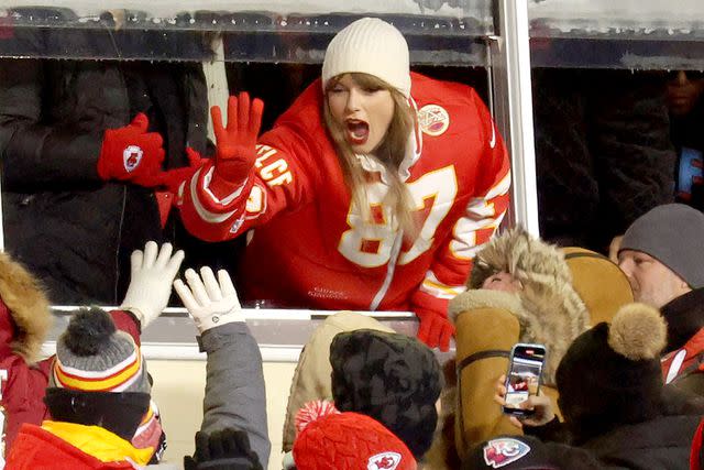 <p>Jamie Squire/Getty</p> Taylor Swift celebrates with fans during the AFC Wild Card Playoffs between the Miami Dolphins and the Kansas City Chiefs at GEHA Field at Arrowhead Stadium on Jan. 13, 2024 in Kansas City, Missouri.