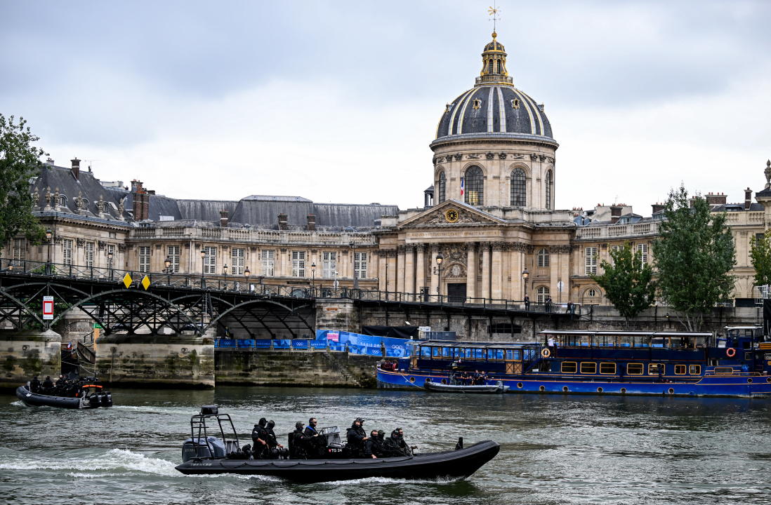 Paris , France - 26 July 2024; Armed Police on boats navigate the River Seine ahead of the Opening Ceremony of the 2024 Paris Summer Olympic Games in Paris, France. (Photo By Stephen McCarthy/Sportsfile via Getty Images)