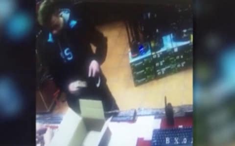 CCTV footage shows Vladislav Roslyakov putting firearm shells into a backpack at an arms shop several days before the attack - Credit: REUTERS