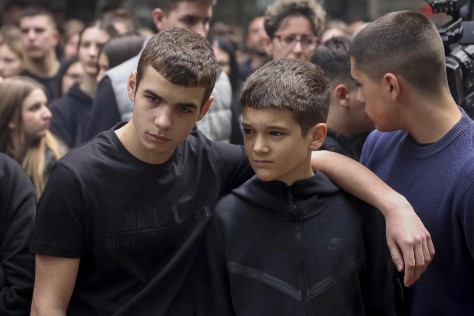 School children mourn the victims near the Vladislav Ribnikar school in Belgrade, Serbia, Thursday, May 4, 2023. Many wearing black and carrying flowers, scores of Serbian students on Thursday paid silent homage to their peers killed a day earlier when a 13-year-old boy used his father’s guns in a school shooting rampage that sent shock waves through the nation and triggered moves to boost gun control. (AP Photo/Armin Durgut)
