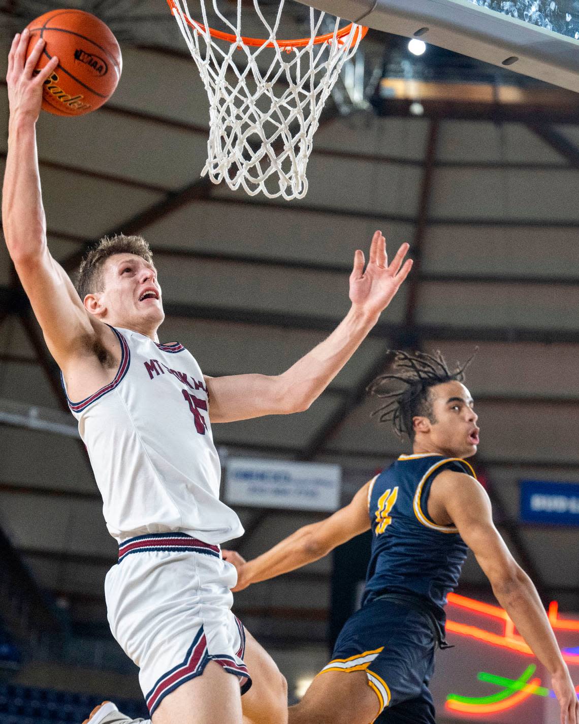 Mount Spokane forward Maverick Sanders goes in for a layup as Bellevue’s Niclas Norrah defends during the second quarter of a Class 3A quarterfinal game on Thursday, March 2, 2023, in Tacoma, Wash.