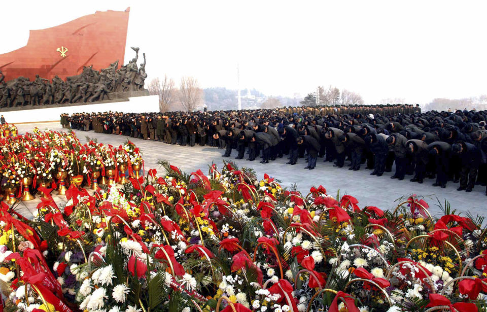 North Koreans offer flowers at Mansudae in Pyongyang on the eve of the second anniversary of the death of former leader Kim Jong Il