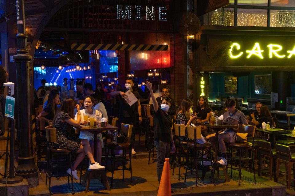 Customers outside restaurants in the Lan Kwai Fong nightlife area in Hong Kong. Photographer: Bertha Wang/Bloomberg