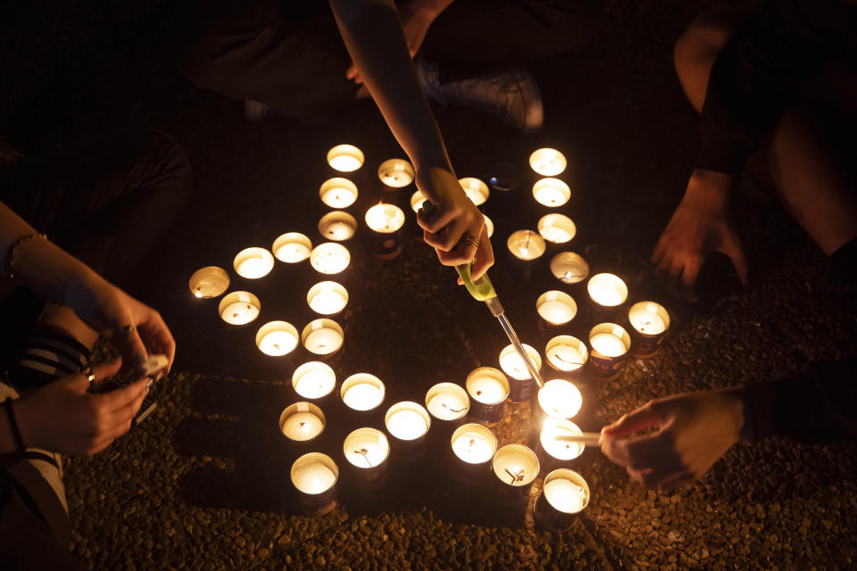 Israelis light memorial candles on the 25th anniversary of the assassination of Israeli Prime Minister Yitzhak Rabin, at Rabin Square, Tel Aviv, Israel, Thursday, Oct. 29, 2020. (AP Photo/Oded Balilty)