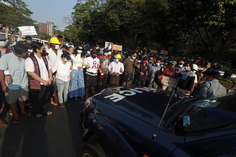 Anti-coup protesters try to prevent a police vehicle from moving forward near the headquarters of the National League for Democracy party in Yangon, Myanmar Monday, Feb. 15, 2021. Security forces in Myanmar intensified their crackdown against anti-coup protesters on Monday, seeking to quell the large-scale demonstrations calling for the military junta that seized power earlier this month to reinstate the elected government. (AP Photo)