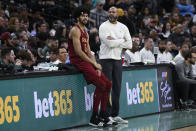 FILE - Cleveland Cavaliers head coach J.B. Bickerstaff, right, speaks with Cleveland center Jarrett Allen during the first half of an NBA basketball game against the San Antonio Spurs, Saturday, Feb. 3, 2024, in San Antonio. The Cavaliers have waited a year to redeem themselves in the NBA playoffs. Their chance starts Saturday against the Orlando Magic. (AP Photo/Darren Abate, File)