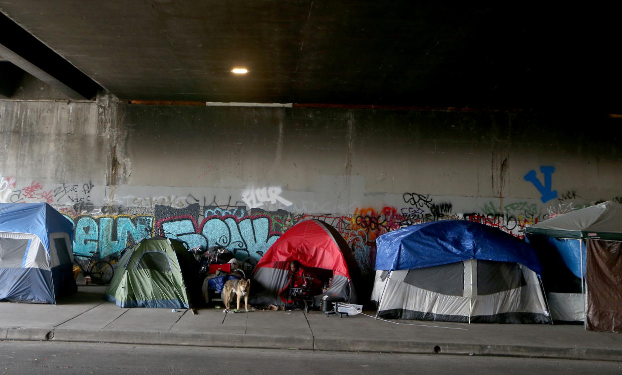 A homeless woman under the 405 Freeway bridge in Culver City, Calif. 