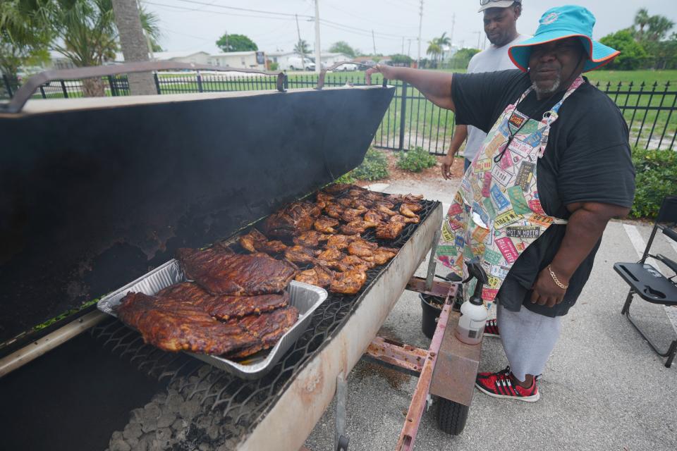 Herbert Hallman shows off his ribs for the barbecue competition Saturday at Boynton Beach's Juneteenth celebration.