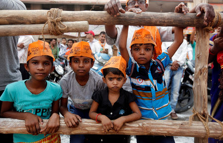 Children wear hats of India’s Prime Minister Narendra Modi Bharatiya Janata Party during a roadshow in Varanasi, India, April 25, 2019. REUTERS/Adnan Abidi