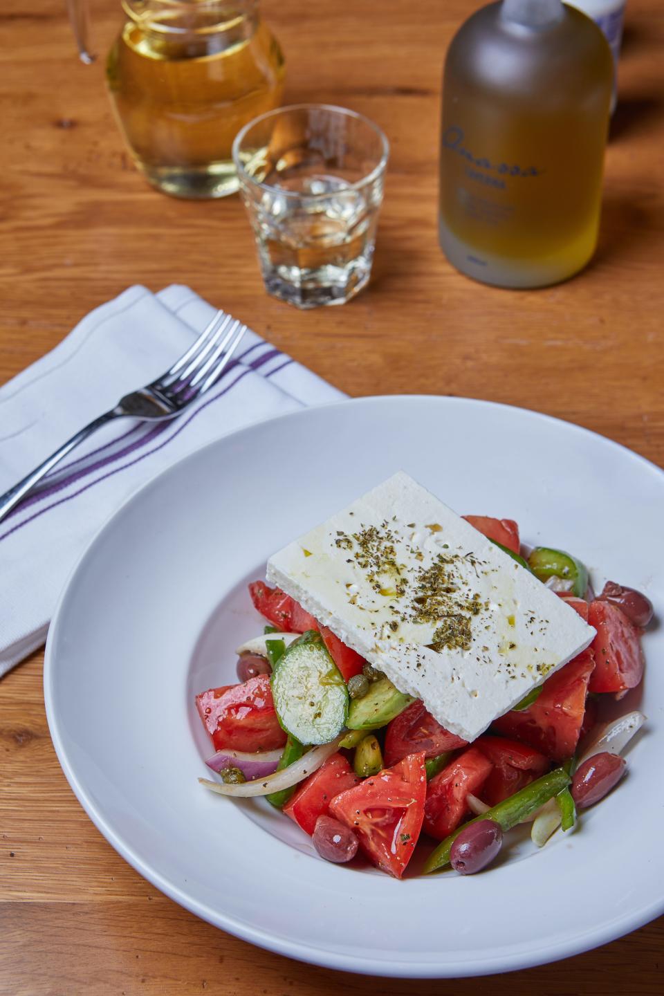 A plate of Greek salad on a table.