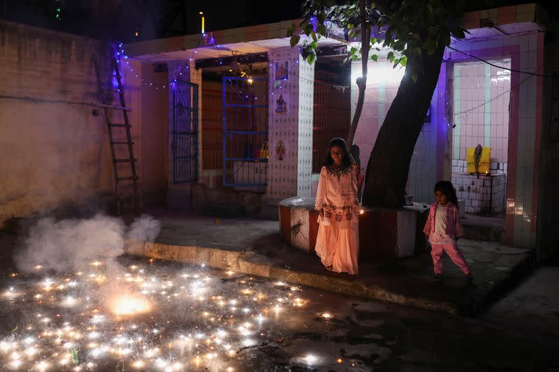 Children light fireworks to celebrate Diwali, in New Delhi