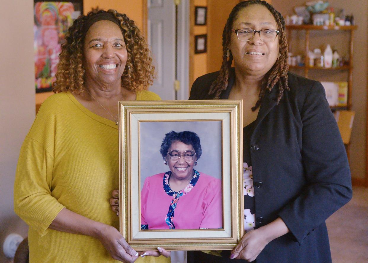 Deborah Jones, 68, left, and her sister Patricia Neal, 59, hold a portrait of their mother Rosemary Neal, who died earlier this year at the age of 93, in Erie. Rosemary Neal was one of the first black nurses hired at Hamot hospital and both of her daughters are nurses as well, with Jones just recently retiring.