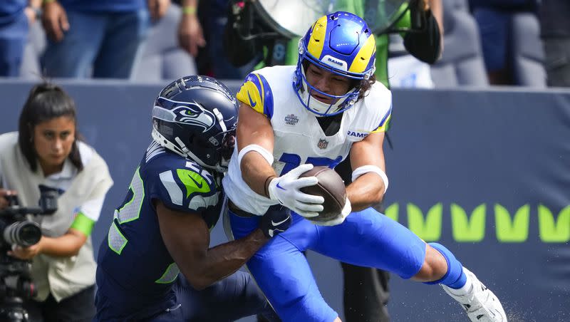 Los Angeles Rams wide receiver Puka Nacua is tackled by Seattle Seahawks cornerback Tre Brown (22) during the first half of an NFL football game, Sunday, Sept. 10, 2023, in Seattle.