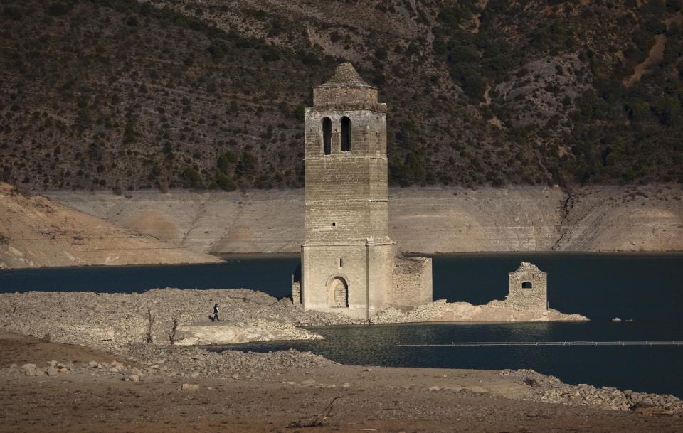 . A church and remains of an ancient village which are usually covered by water are seen inside the reservoir of Mediano, in Huesca, Spain, Tuesday March 13, 2012. The reservoir built in the 1950s, submerging a village called Mediano and its 16th century church, is so low on water that the ruins of buildings which are usually under water are now uncovered. Spain is suffering the driest winter in more than 70 years, adding yet another woe for an economically distressed country that can scarcely afford it. Thousands of jobs and many millions of euros could be in jeopardy. (AP Photo/Emilio Morenatti)