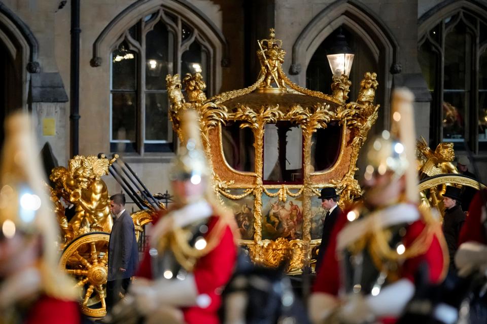 The Gold State Coach is led in a procession as it leaves Westminster Abbey in central London, early Wednesday, May 3, 2023, during a rehearsal for the Coronation of King Charles III which will take place at Westminster Abbey on May 6.