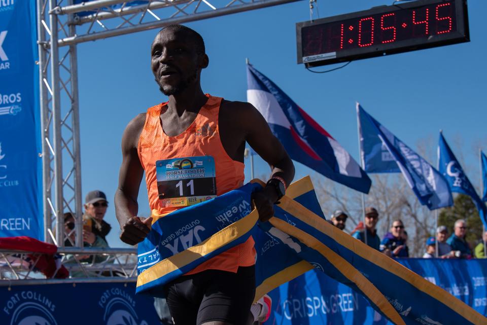 First-place finisher Lawrence Kipkoech crosses the finish line of the 50th Horsetooth Half Marathon on April 16, 2023, in Fort Collins.