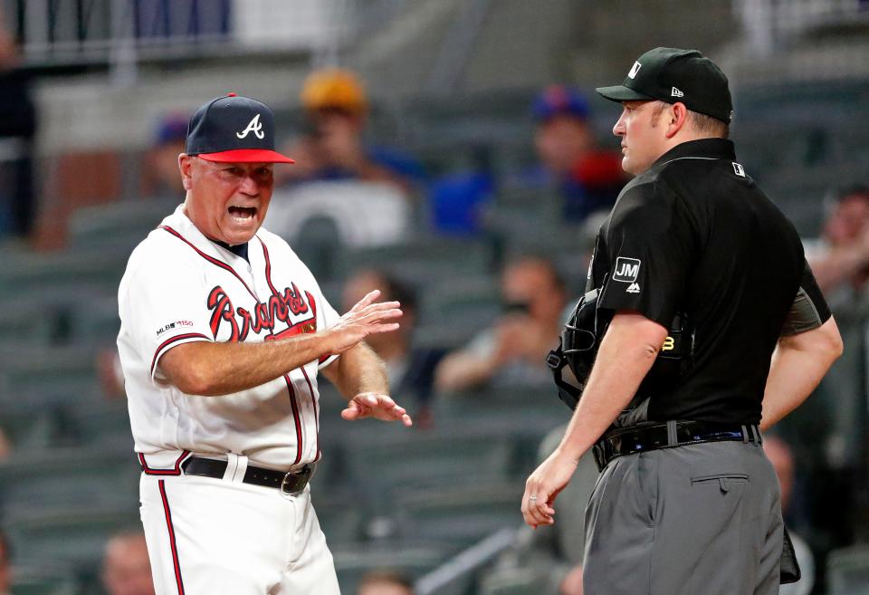 Atlanta Braves manager Brian Snitker argues with home plate umpire Dan Bellino (2) during the eighth inning of the team's baseball game against the New York Mets on Thursday, April 11, 2019, in Atlanta.