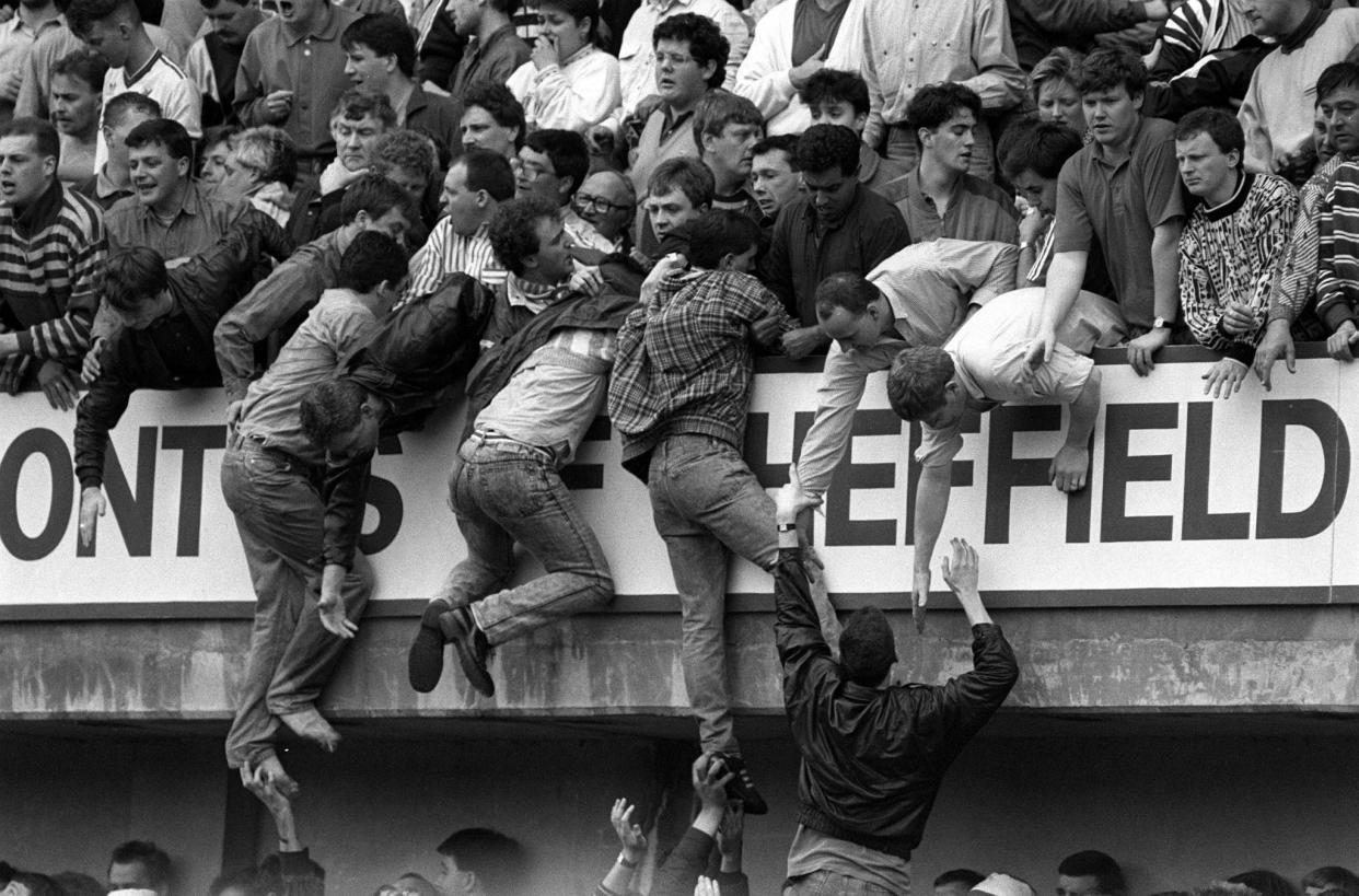 Liverpool fans try and escape the crush at the Leppings Lane end 