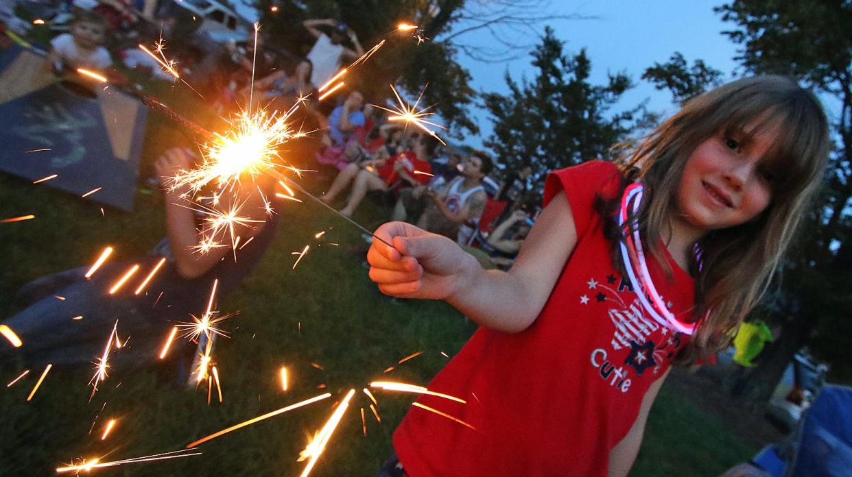 Elizabeth Gustashaw (6) enjoys a sparkler prior to the start of the big fireworks display in 2016.